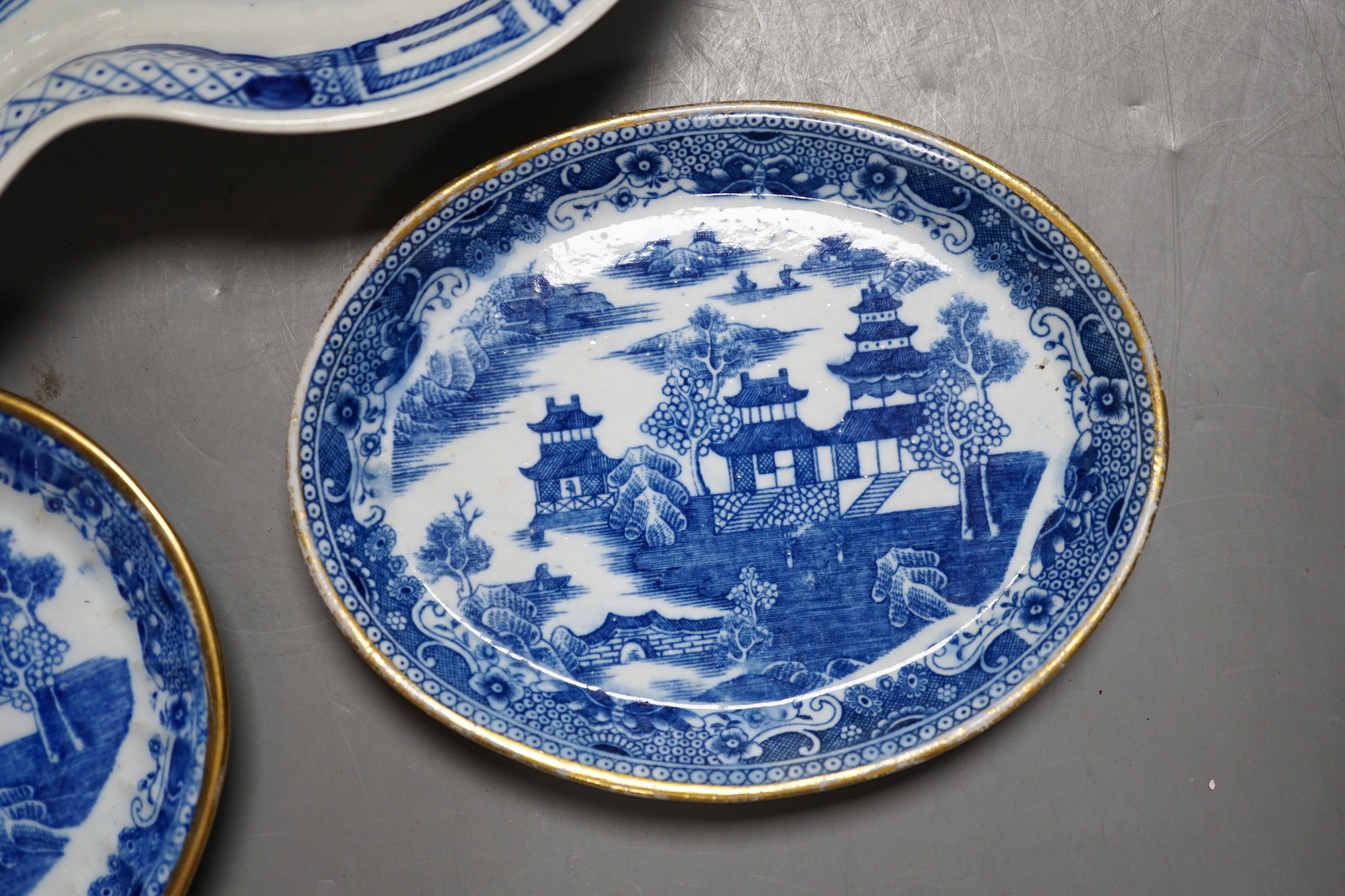 A Caughley heart shaped dish, painted with the Weir pattern, 26.5cm and two trays printed with the Scalloped Bridge pattern